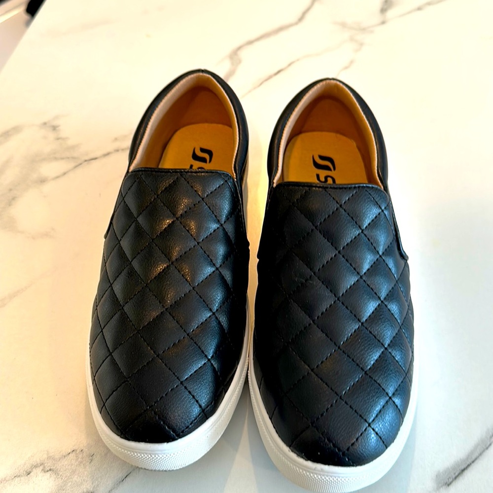 Black slip on sneakers, size 7.